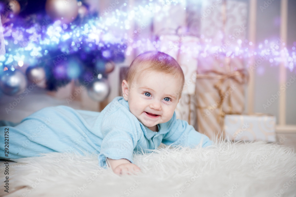 Cute baby on floor at Christmas tree Cute baby on floor at Christmas tree