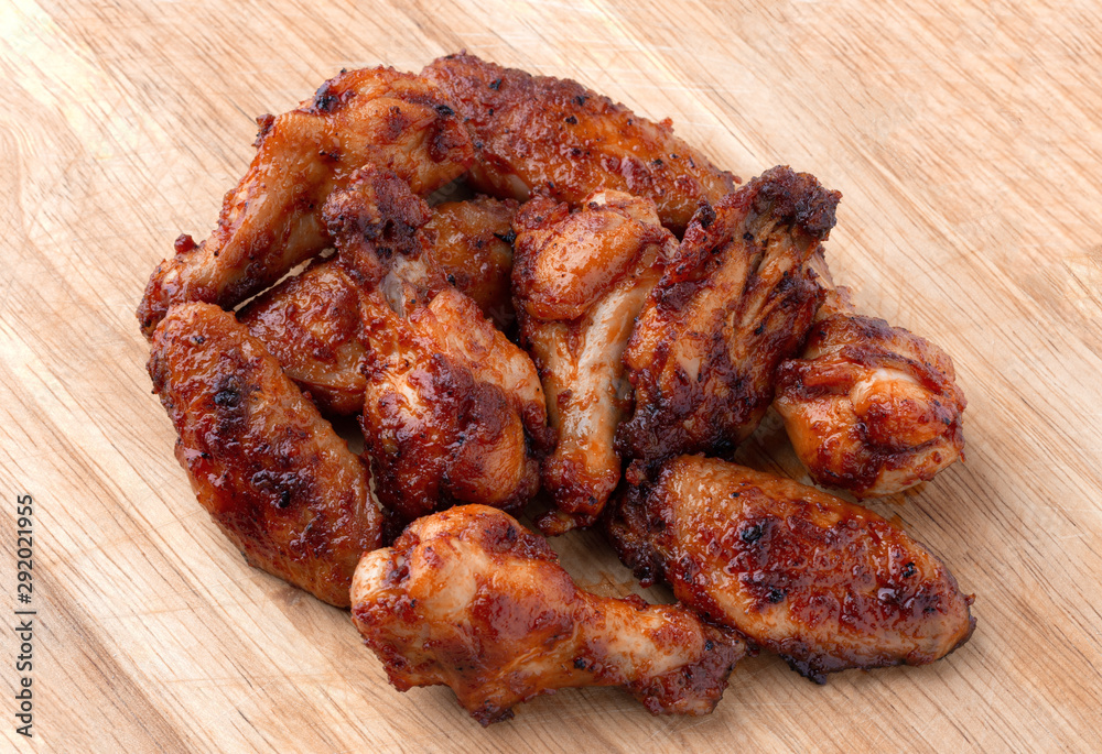 Fried wings close-up. Buffalo wings on a wooden board. Fried wings close-up. Buffalo wings on a wooden board.