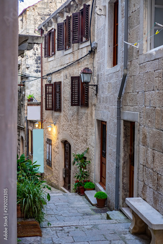 Famous narrow stone street with stone houses and facades and lanterns in historic fortified Korcula town  Korcula Island  Dalmatia  Croatia