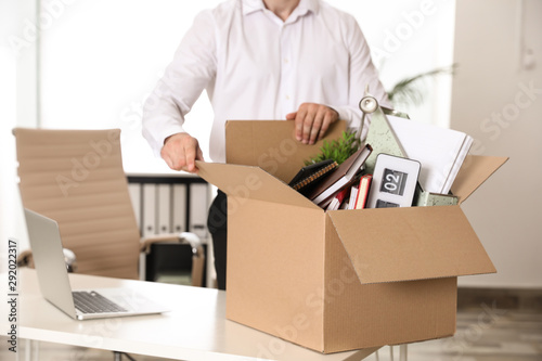 Young man with box of stuff in office, closeup © New Africa