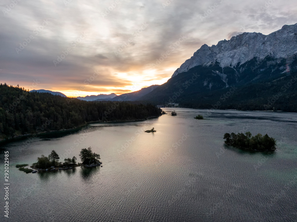 Fototapeta premium Aerial of the Eibsee lake and Zugspitze mountain in Bavaria, Germany at sunrise