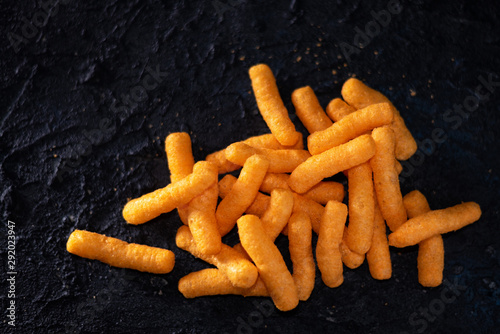 Snacks, crochets or cheese puff pastry on dark background