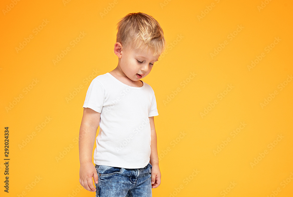 Fashionable little boy posing in jeans.