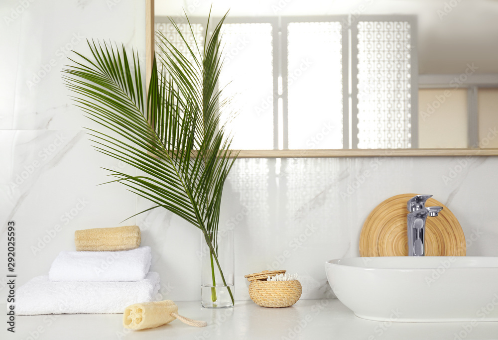 Fototapeta premium Tropical palm leaves in stylish bathroom interior