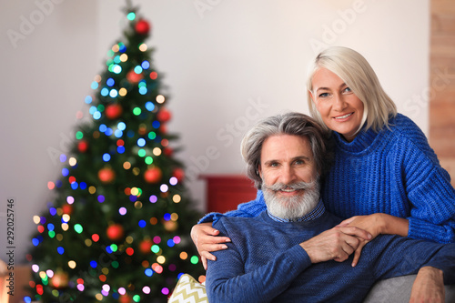 Happy mature couple celebrating Christmas at home