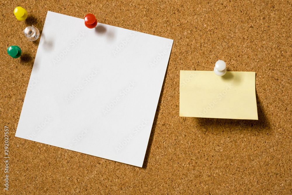 Note paper sheets pinned to a cork board with push pins. Office style design.