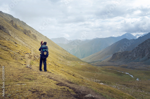 Man taking picture of the beautiful mountains © Ольга Ким