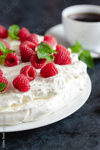 Meringue with whipped cream, raspberries.and mint