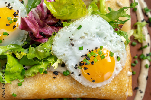 Fried eggs, macro shot, sprinkled with spices and green onions.