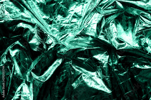 The texture of the crumpled fabric is metallic green color for your background.