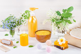 Natural body care products and accessories lay out with flowers and leaves. Eco friendly spa, beauty cosmetics concept