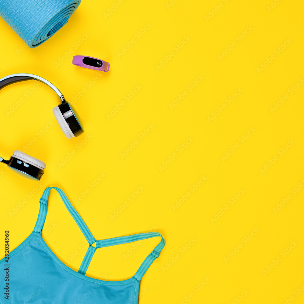 Layout of sport clothes and fitness accessories for women with fruits on yellow background. Layout of sport clothes and fitness accessories for women with fruits on yellow background.