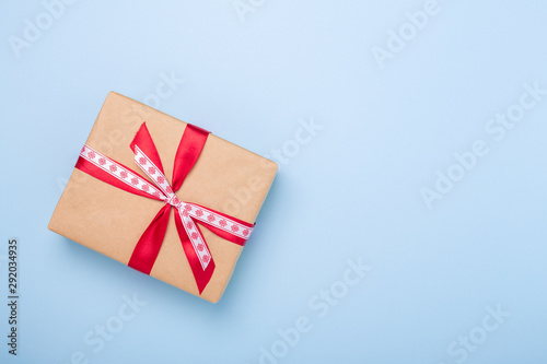 Christmas gift box on blue background. Top view with copy space - Image