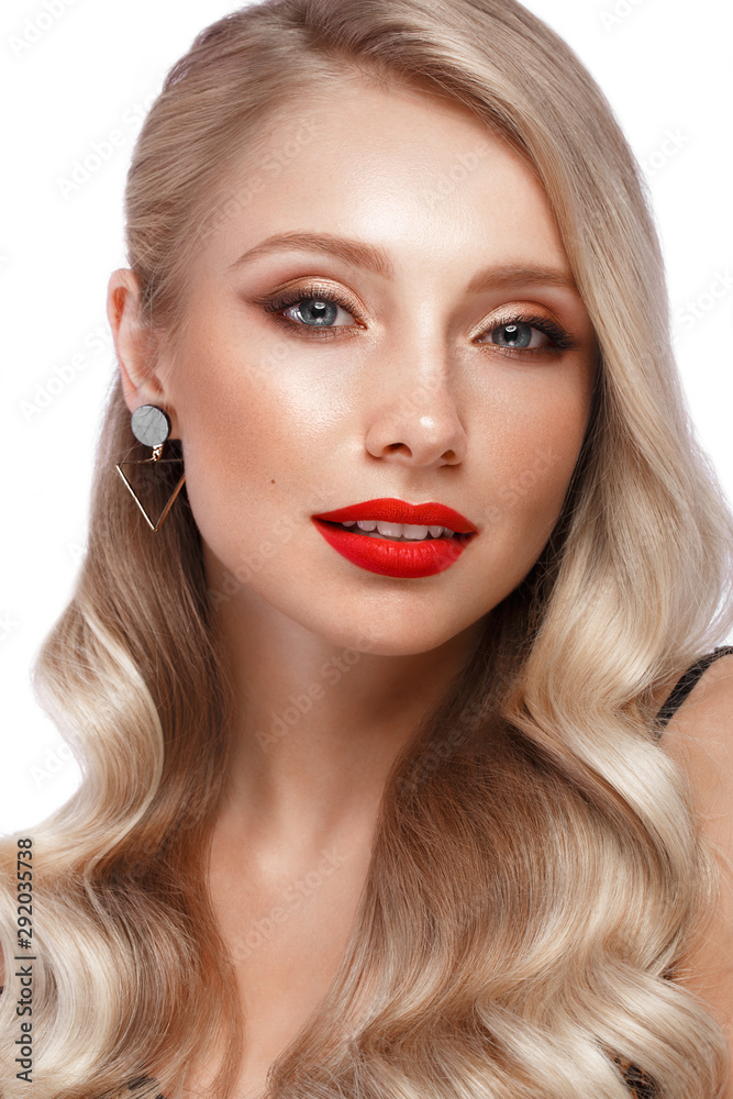 Beautiful blonde in a Hollywood manner with curls, natural makeup and red lips. Beauty face and hair. Beautiful blonde in a Hollywood manner with curls, natural makeup and red lips. Beauty face and hair.