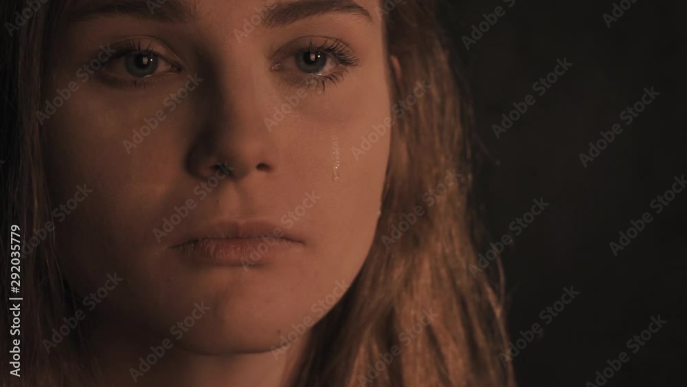 Woman is crying in the dark
