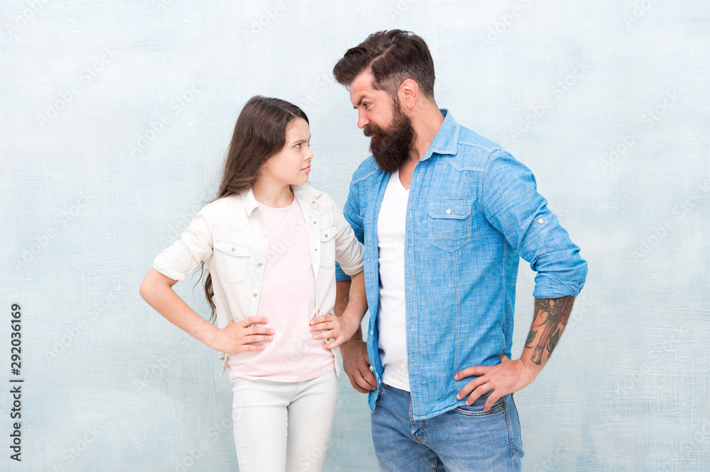 Conflict and offence. Sometimes parenting is about misunderstanding. Family conflict. Bearded hipster man and child girl. Confrontation concept. Frowning man and serious daughter. Solving conflict