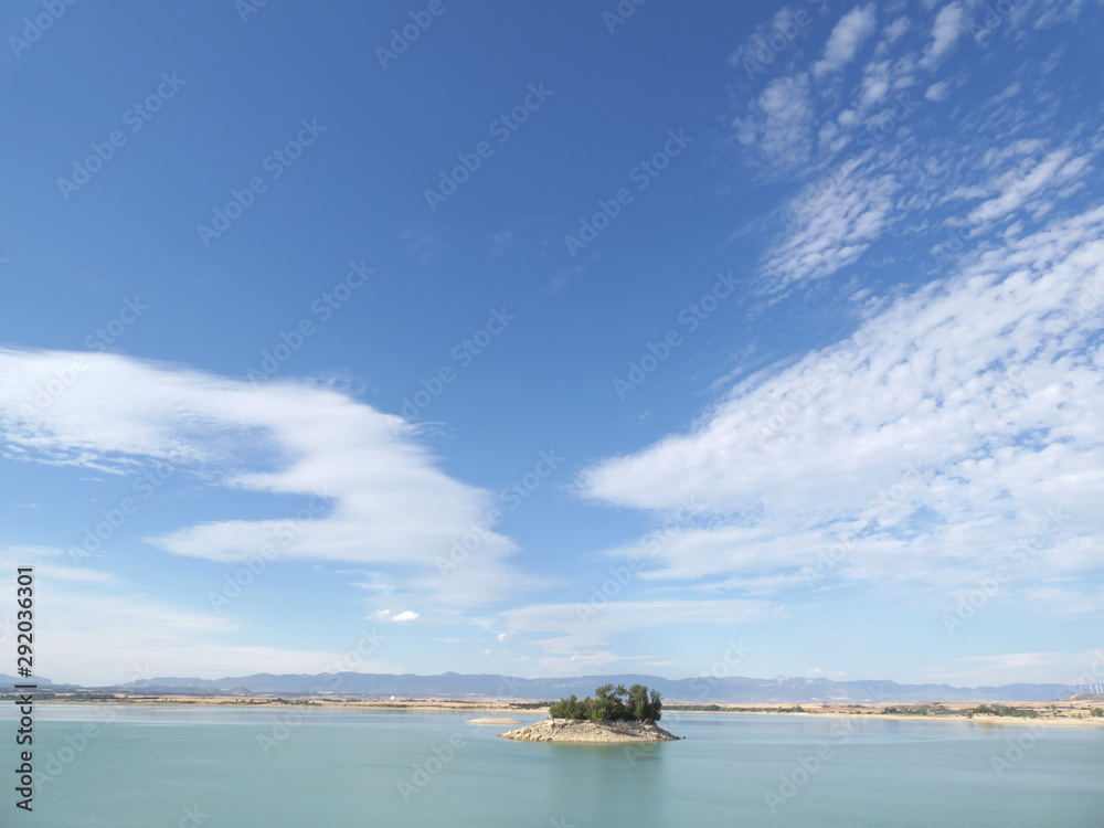 View of lake with blue sky and clouds