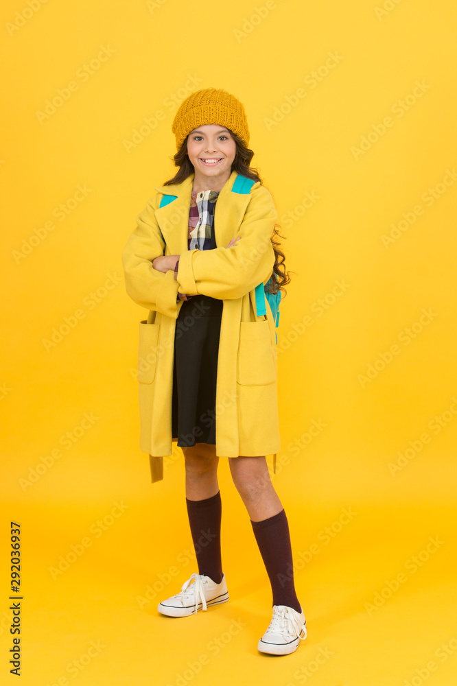 Fototapeta premium Schoolgirl fancy child. Aesthetics of clothes. Fall outfit. Modern teen outfit concept. Outfit for daily school life. Feeling cool and stylish. Fall fashion. Little girl wearing stylish hat and coat