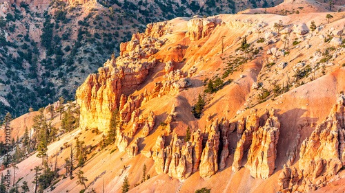 Panoramic closeup view from Bryce Point overlook of orange colorful cliff and hoodoos rock formations in Bryce Canyon National Park at sunset