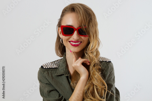 Closeup woman face in red sunglasses isolated on white background. Girl in shirt, red lips makeup. Fashion Beauty concept. Beautiful face skin and fashionable accessories. Glamour style long hair