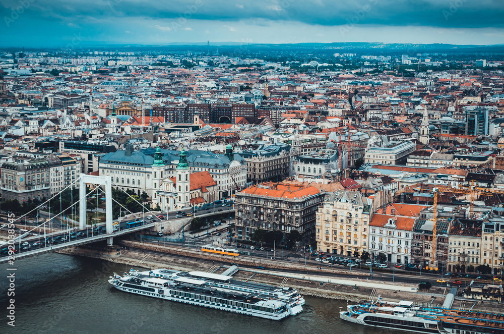 Cityscape of Budapest, Hungary, panoramic top view. Danube river with cruise ships and old town. Landmark famous place. Cloudy weather. Soft focus. Old historic buildings. Travelling to Europe