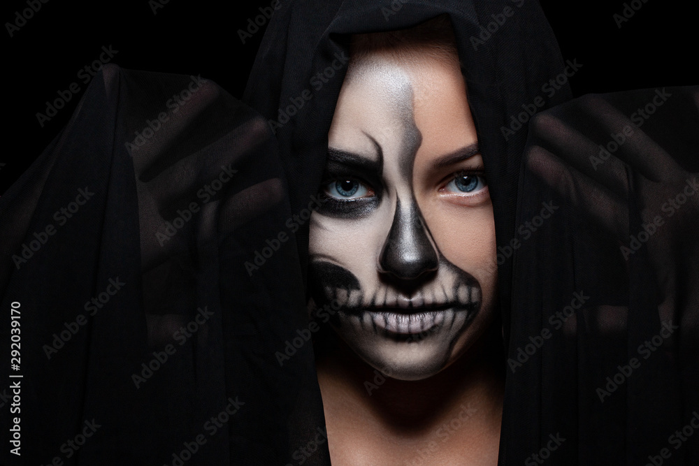 Halloween. Portrait of young beautiful girl with make-up skeleton on her face Halloween. Portrait of young beautiful girl with make-up skeleton on her face