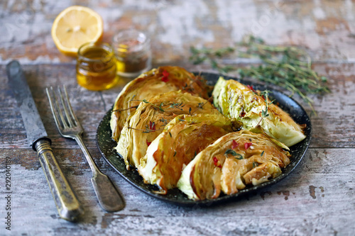 Baked cabbage slices with herbs. Vegan recipes. photo