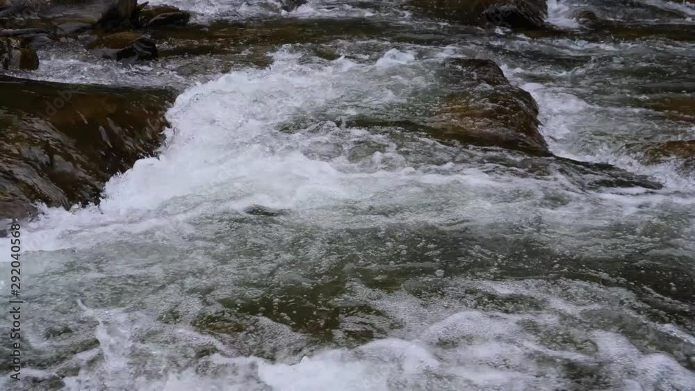 Boiling water of a mountain river in the mountains in summer Boiling water of a mountain river in the mountains in summer