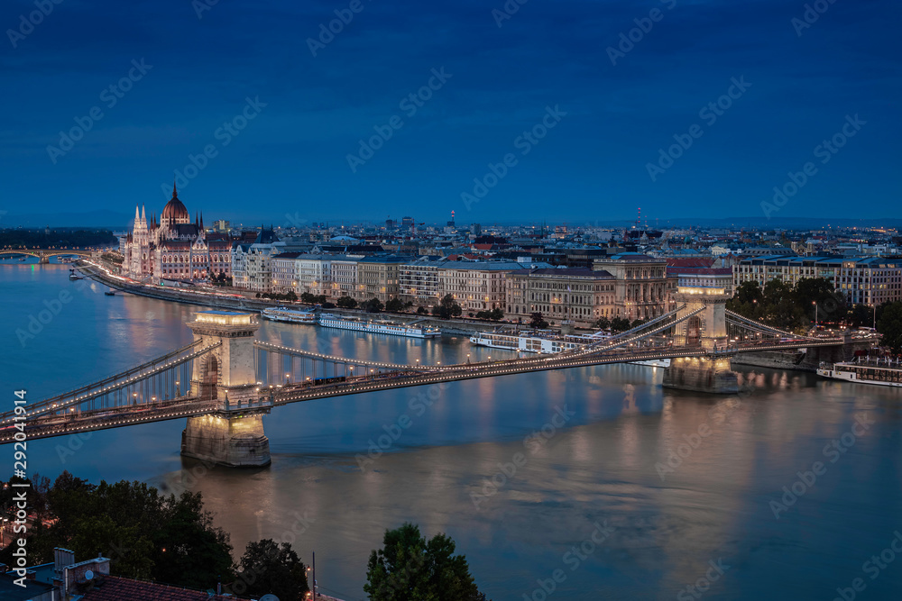 Budapest, Hungary - Aerial skyline view of Budapest with the famous illuminated Szechenyi Chain Bridge and Hungarian Parliament building at dusk