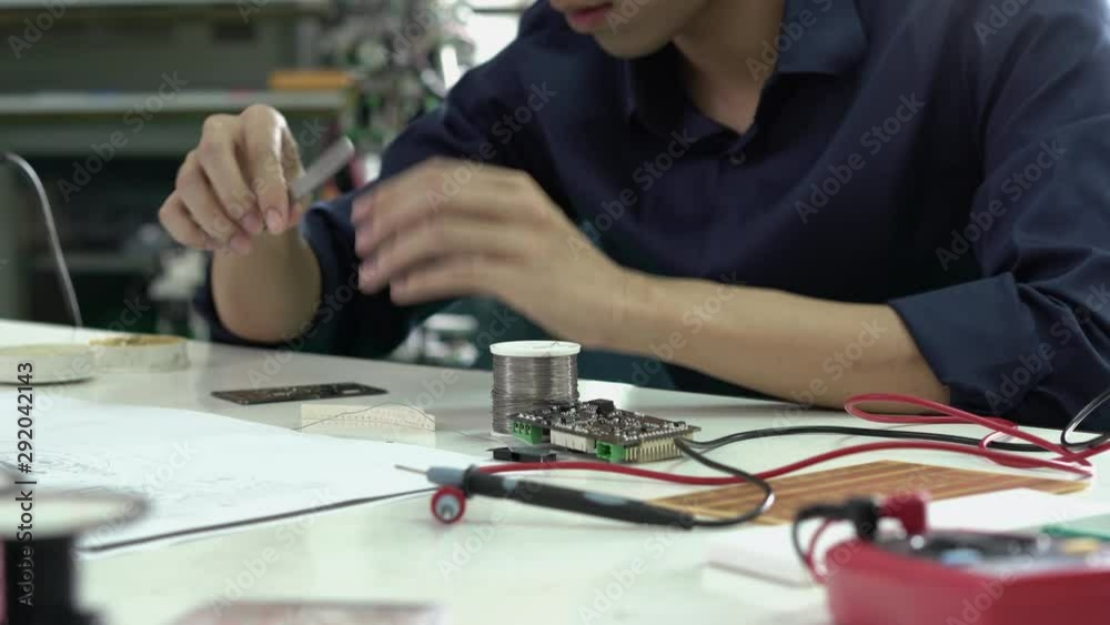 Asian engineer students are assembling and testing electric circuit in modern laboratory. Concept of configuration, technological developments and innovation.