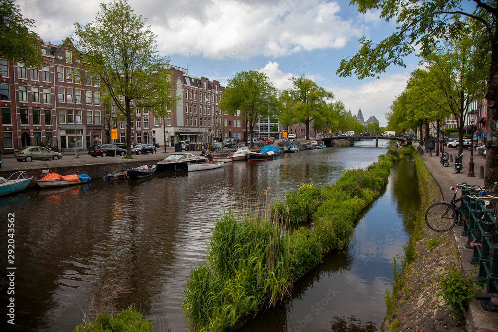 Embankment of Amstel canal in Amsterdam at summer day, Netherlands