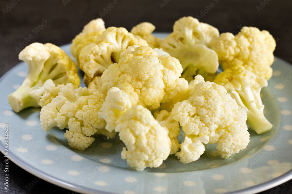 cauliflower close-up on blue plate with gray background cauliflower close-up on blue plate with gray background