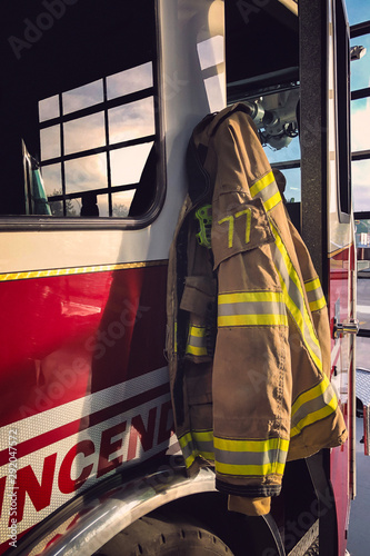 Fotografie, Obraz Firefighter clothe hanging on the firetruck in the fire station