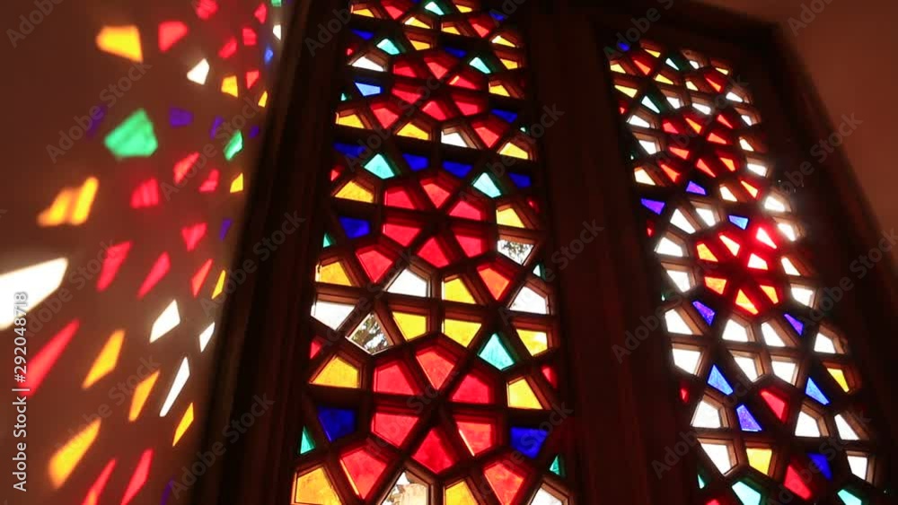 Beautiful stained glass windows with sunlight in the background