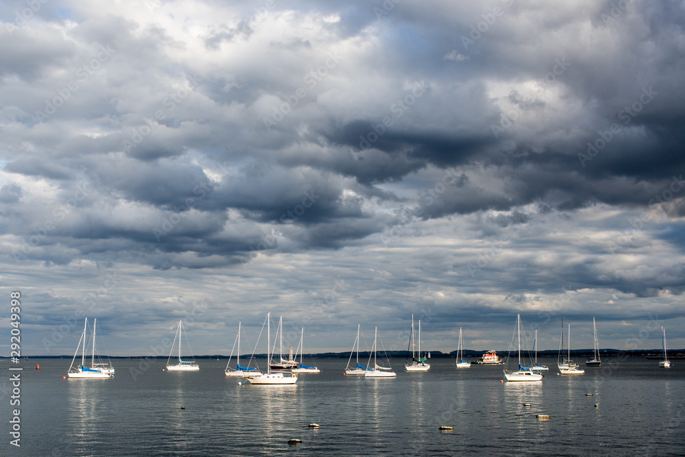 Sailboats in bay summer dramatic sky