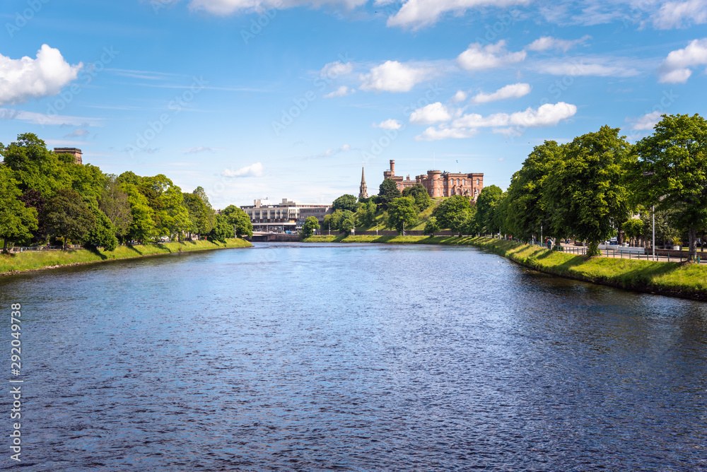 Beautiful view of river Ness flowing through Inverness, Scotland, on a clear summer day