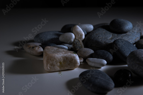 gray white and black sea pebbles on a white background