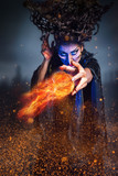 Scary witch conjuring a fireball