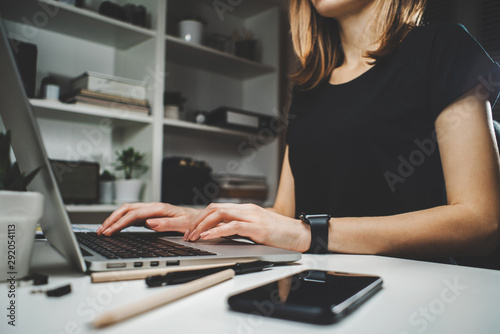 Female freelancer working at home using her laptop