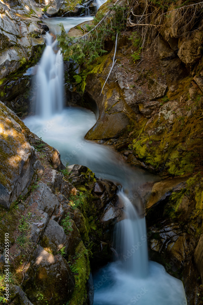 Fototapeta premium Water Streams Through Carved Rocks Above Christine Falls