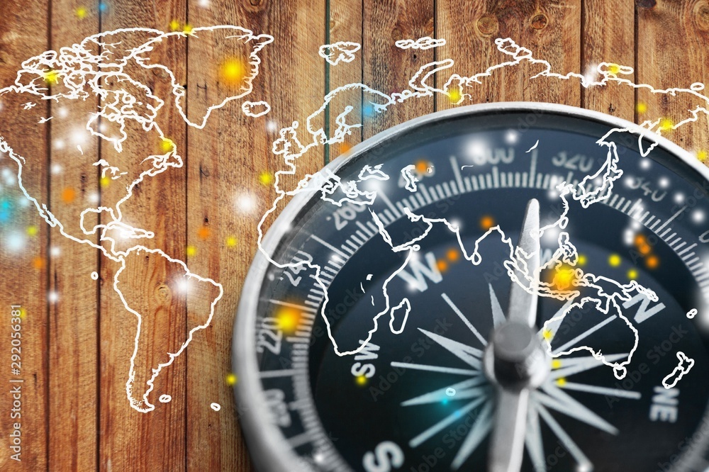 Fototapeta premium Classic compass on wooden desk and world illustration