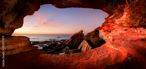 Looking out from a small cave at  Gantheaume Point  Broome  Western Australia at sunset photo