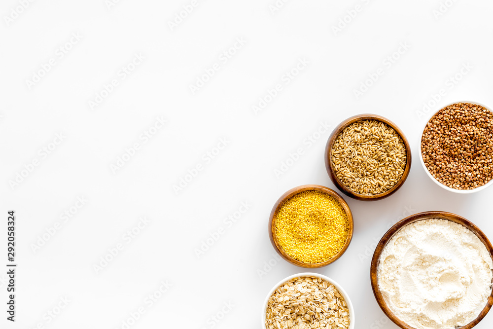 Healthy food concept. Cereals in bowls on white background top view frame copy space Healthy food concept. Cereals in bowls on white background top view frame copy space