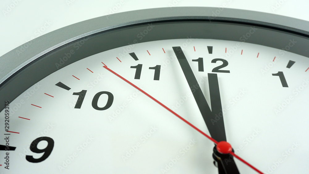 Gray wall clock face beginning of time 11.58 am or pm on White background, Copy space for your text, Time concept.. Gray wall clock face beginning of time 11.58 am or pm on White background, Copy space for your text, Time concept..