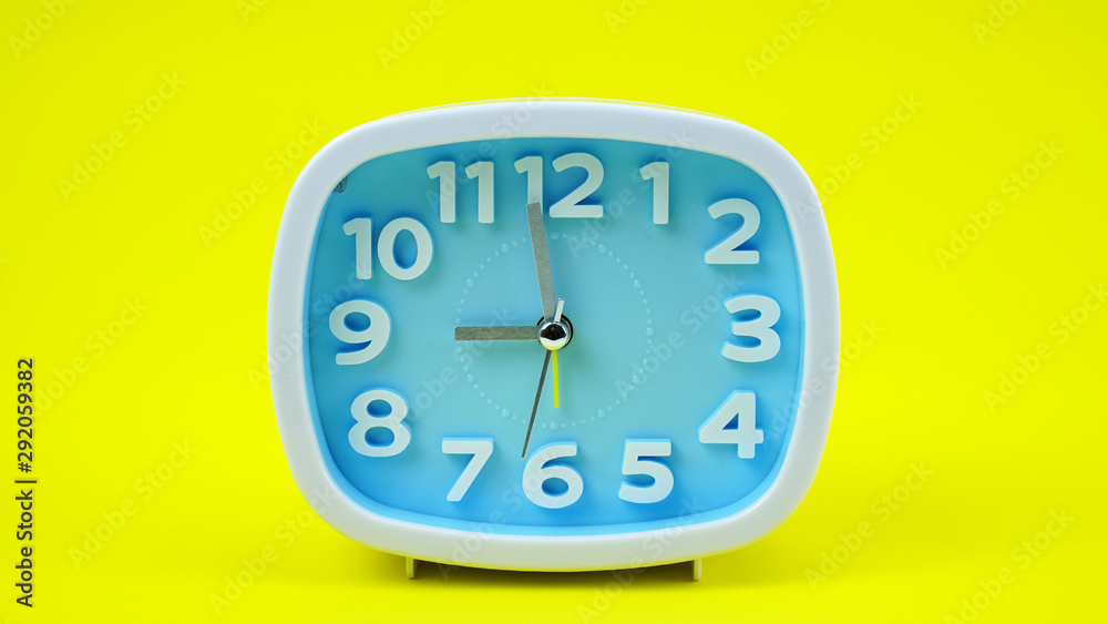 Blue Alarm clock face beginning of time 08.57 on Yellow background, Copy space for your text, Time concept. Blue Alarm clock face beginning of time 08.57 on Yellow background, Copy space for your text, Time concept.