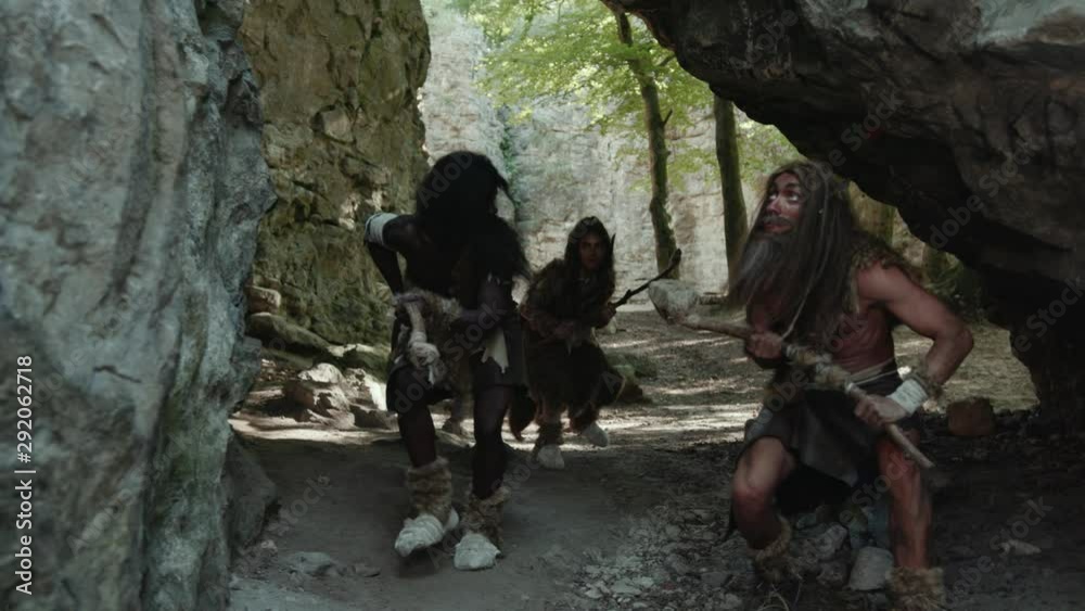 Prehistoric african tribe of hunter-gatherers hunting in the woods in rocky landscape. Primitive first people family. Evolution concept.