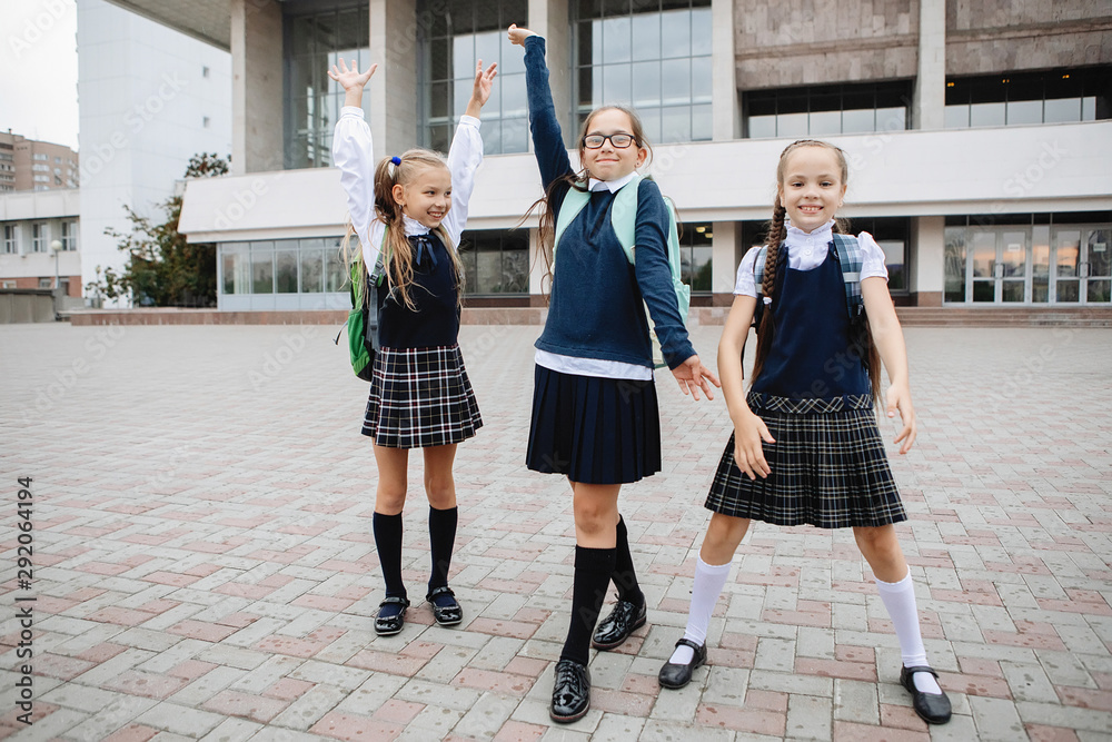 Three schoolgirls in uniform.