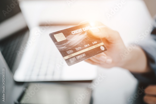 beautiful Woman showing credit card and laptop before shopping website online, shopping concept photo