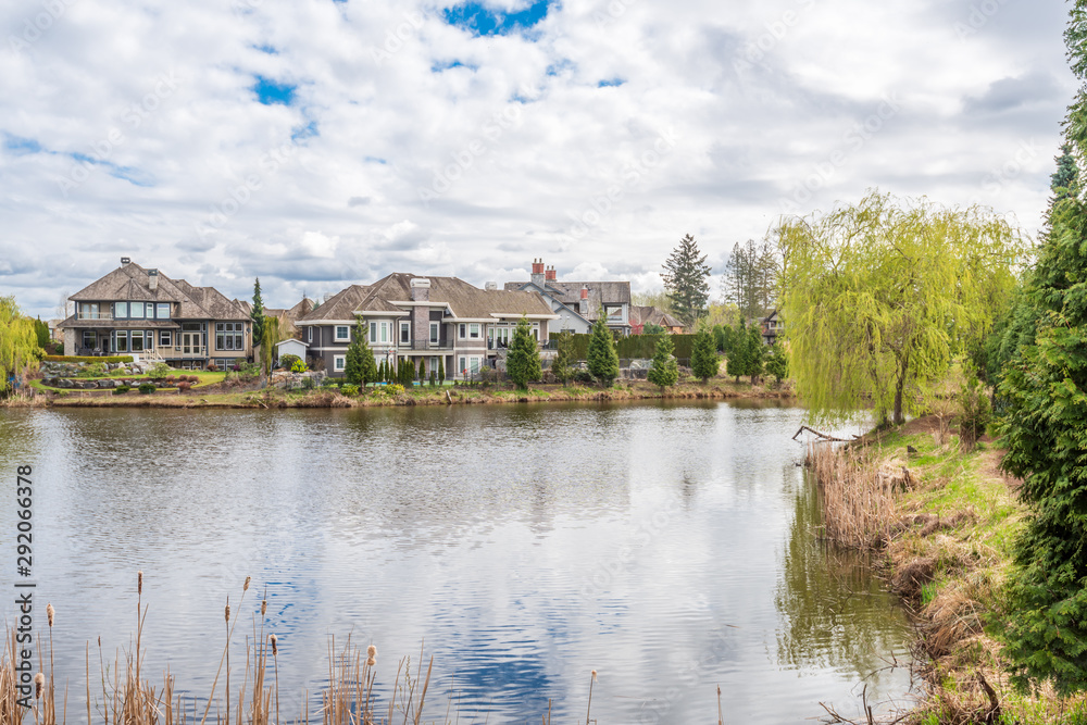 A perfect neighbourhood. Houses in suburb at Summer in the north America. Luxury houses with nice landscape.