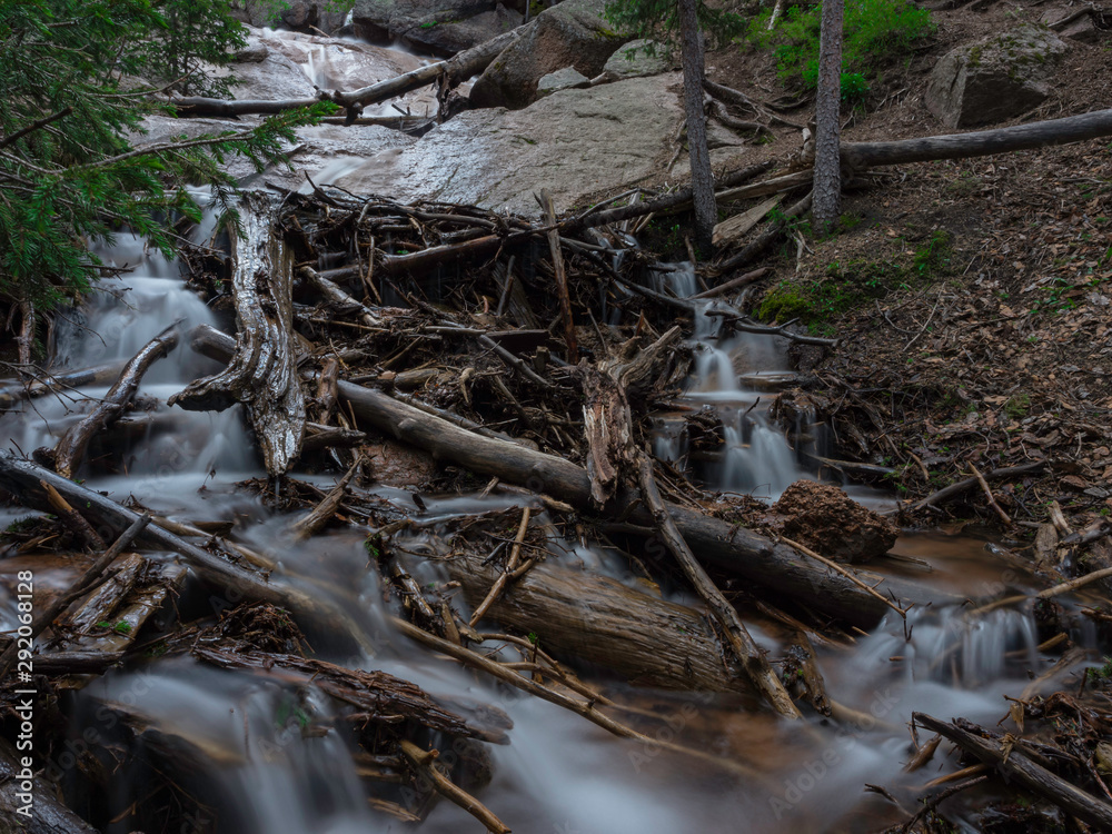 Long Exposoure showing flowing water and fallen wood Long Exposoure showing flowing water and fallen wood
